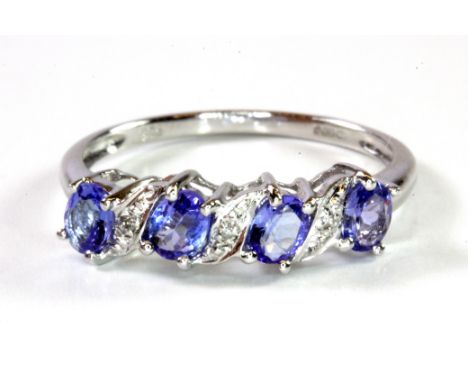 A 9ct white gold tanzanite and diamond set ring, (N.5).