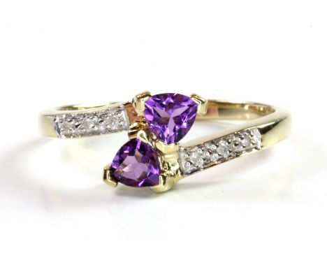 A 9ct yellow gold amethyst and diamond set crossover ring, (P.5).