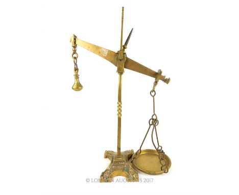 A set of early 20th century brass scales, the twisted stem terminating in splayed foot with four lion paw feet, 56cm high