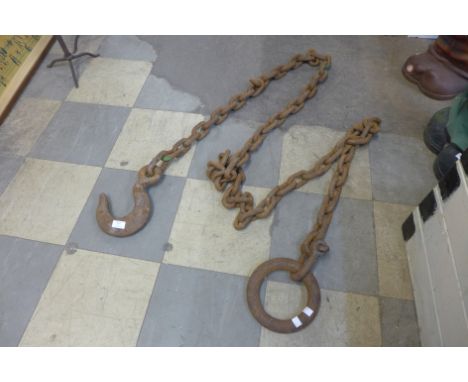 A heavy iron logging chain with hook and a ring 