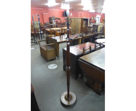 A carved oak standard lamp 