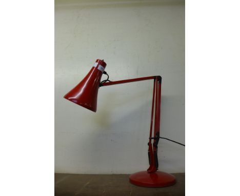 A red metal anglepoise desk lamp 