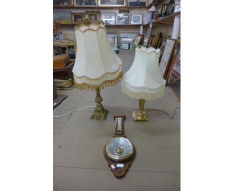 A mahogany aneroid barometer and two brass table lamps 