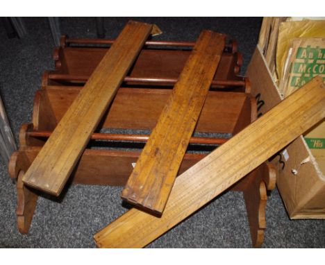 A shaped mahogany plate rack; three Tomlinson's Equivalent Paper Slide scales (4)
