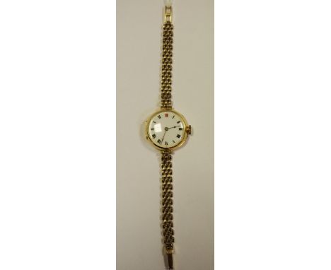 A mid 20th century large 9ct gold lady's watch, white enamel face, black Roman numerals, 9ct gold bracelet gross weight 23.6g
