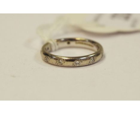An 18ct white gold eternity ring, set with diamond chips, 3.8g size K