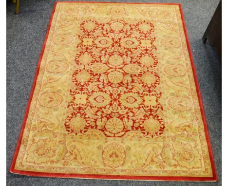 A Sarouk wool carpet in shades of claret and gold