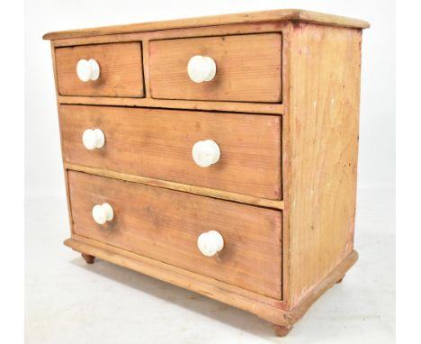 A late 19th/early 20th century miniature pine chest of two short over two long drawers with ceramic handles on turned feet, 3