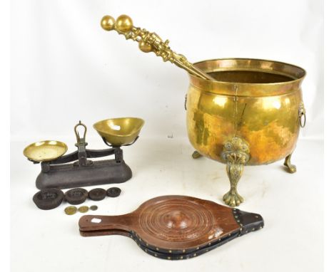 A large Dutch style brass coal or log bin raised on paw feet, a set of scales, bellows, fire irons, reproduction fire mark et