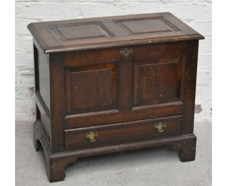 A reproduction oak coffer of small proportions, the hinged lid enclosing storage compartment above single base drawer, raised
