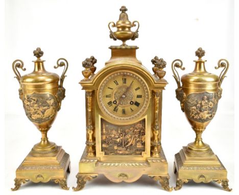 A D MOUGIN; a late 19th century French ormolu eight day gong strike mantel clock and garniture, the clock with urn finial abo