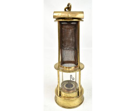 An early 20th century four bar Clanny-type flame safety lamp with copper gauzes and underside screw lock, indistinct inscript