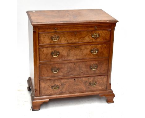 A reproduction burr walnut veneered chest with brush slide above four drawers on ogee bracket feet, 83 x 77 x 46.5cm.Addition