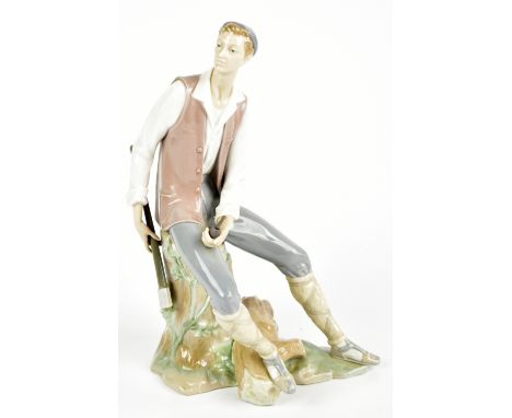 LLADRO; a figurine depicting a seated lumberjack holding a pipe, height 37cm, printed factory marks to base.Additional Inform