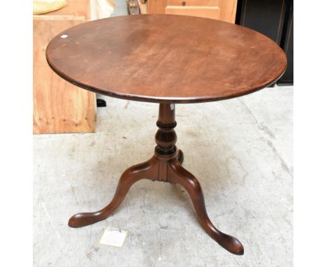 A George III mahogany tilt top tripod table with birdcage action, raised on three out-swept supports, height 71.5cm, diameter