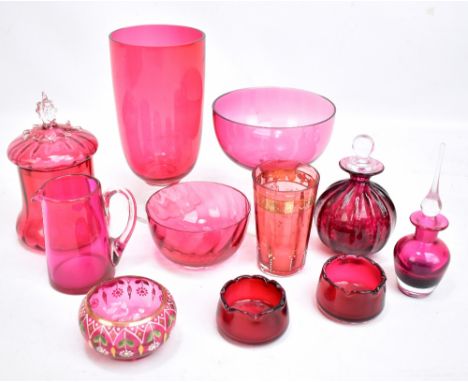 A small group of cranberry glass including vase, lidded scent bottles, bowls etc, two with gilt and enamel decoration.Additio