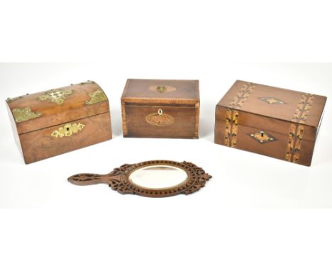 A 19th century burr walnut veneered twin division tea caddy of domed form, with Gothic brass mounts and ivory plaque to lid c