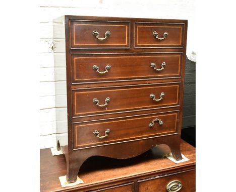 A reproduction mahogany and inlaid narrow chest of two short over three long drawers, raised on bracket supports, height 75.5