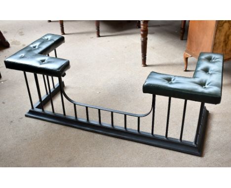 A 19th century wrought iron club fender with green leatherette seat and corner cushions, height 58cm, length 164cm, depth 64c