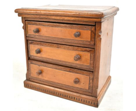 A late 19th/early 20th century oak apprentice chest of three drawers with inlaid checkered base, height 20cm.Additional Infor