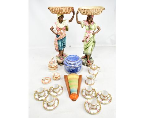 A pair of large early 20th century polychrome decorated ceramic Blackamoor figures, male (af) and female in traditional dress