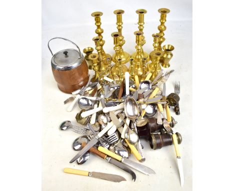 A mixed lot of assorted metalware including an Indian white metal inkwell, assorted brass candlesticks, silver plated flatwar