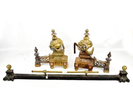 A pair of French brass and champlevé enamel decorated fire irons, height approx 37cm and an iron brass mounted curb (3).

