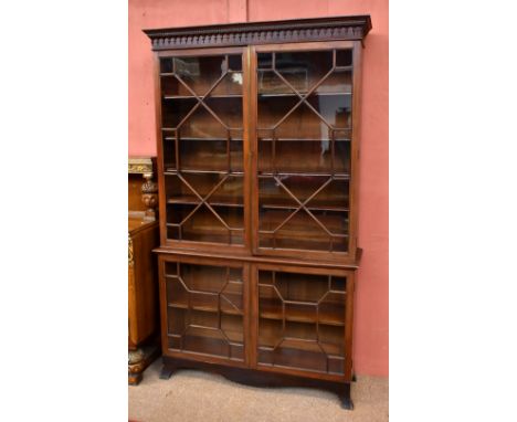 A George III mahogany glazed bookcase, the upper section with moulded dentil cornice above frieze with twin astragal glazed d