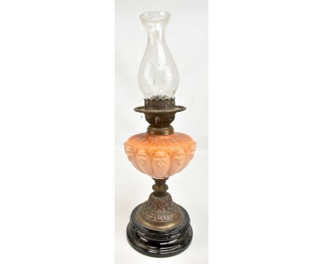 A Victorian oil lamp with peach glass reservoir and foliate detailed foot to circular base (lacking shade), height excluding 