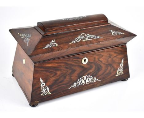 A 19th century rosewood mother of pearl inlaid sarcophagus form tea caddy with two lidded compartments and vacant jar compart
