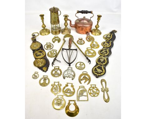 A collection of 19th century and later metalware to include The Protector miners' lamp, assorted horse brasses, copper kettle