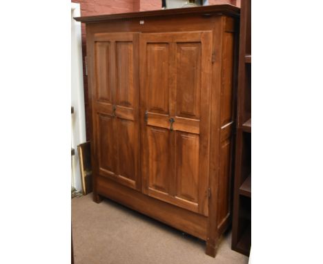 



A large French 19th century walnut wardrobe with moulded dentil cornice above twin panelled doors, the interior fitted wi