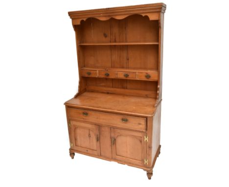 A stained pine dresser, the upper section with plate rack back and one fixed shelf above four spice drawers, the base with on