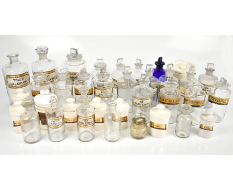 Fifteen assorted glass pharmacy bottles including a large example with original glass labels including a blue glass example w