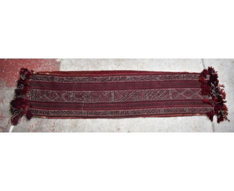 A red ground runner with geometric detail, approx 220 x 56cm.Additional InformationSome light fraying and general wear.