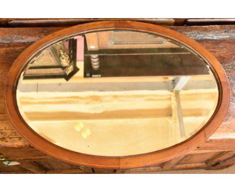 An Edwardian mahogany and line inlaid oval wall mirror with bevelled plate, 69 x 49cm.Additional InformationFormerly from a d