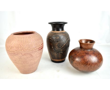 Three contemporary ceramic vases to include an example with original label Banyu Embulan Art Shop, height 22cm (af).

Additio