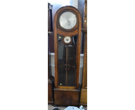 An early 20th century oak cased longcase clock, with arched top, the silvered dial set with Arabic numerals above circular ba