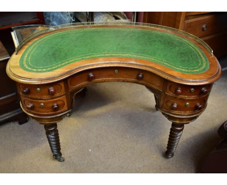 A 19th century mahogany kidney-shaped writing desk with brass gallery and gilt tooled green leather writing surface above arr