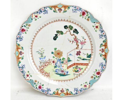 A late 18th/early 19th century Chinese Export charger with shaped rim, typical interior scene to centre and foliate detail to