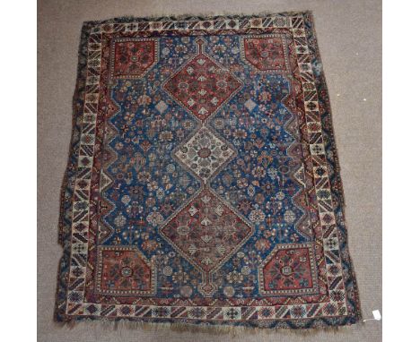 A 19th century Hamadan rug with three central conjoined lozenge shaped medallions with a device set blue ground main rectangu