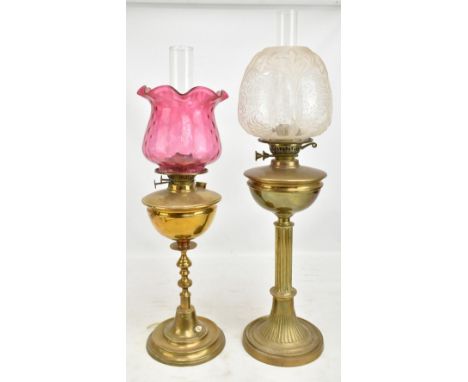 Two late 19th/early 20th century brass oil lamps, the first with foliate moulded and etched shade on fluted column, the secon