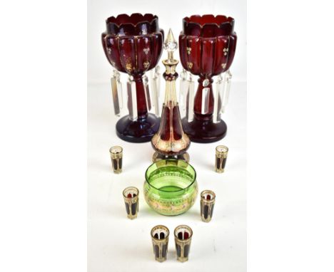 A pair of late 19th century ruby glass table lustres with gilt and enamelled detail, suspending clear prismatic drops, height