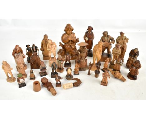 A collection of 19th century and later Black Forest and other carved wooden figurines and bottle stoppers to include a gnome,