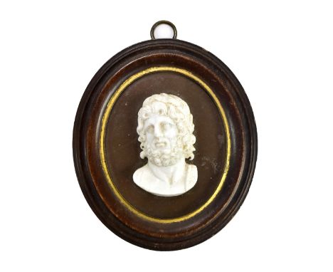 A 19th century glass relief portrait panel, in the manner of James Tassie, depicting a bearded gentleman, 8.5 x 7.5cm.