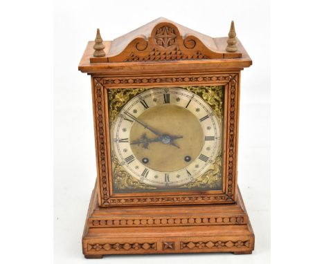 WINTERHALDER &amp; HOFMEIER; a circa 1900 German walnut mantel clock with carved detail, the silvered chapter ring set with A