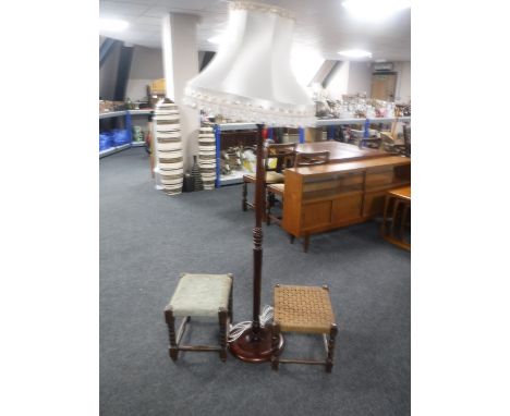 A mahogany standard lamp with shade together with two oak footstools