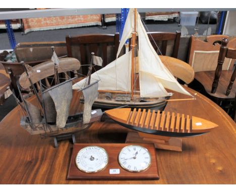 Two wooden ship models together with a wooden boat CD rack and an Abbey ship's style wall clock and barometer