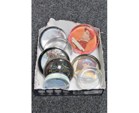 A box containing six vintage glass paperweights, two bearing Ogden's cigarette advertising