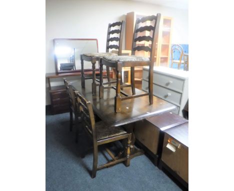 An Ercol refectory dining table together with a set of four ladder back chairs